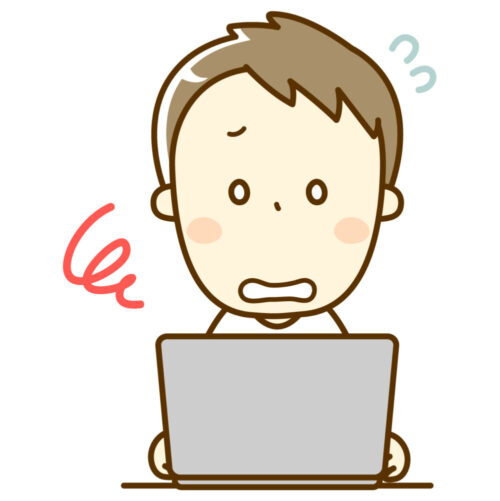 PCの前で困惑する男性